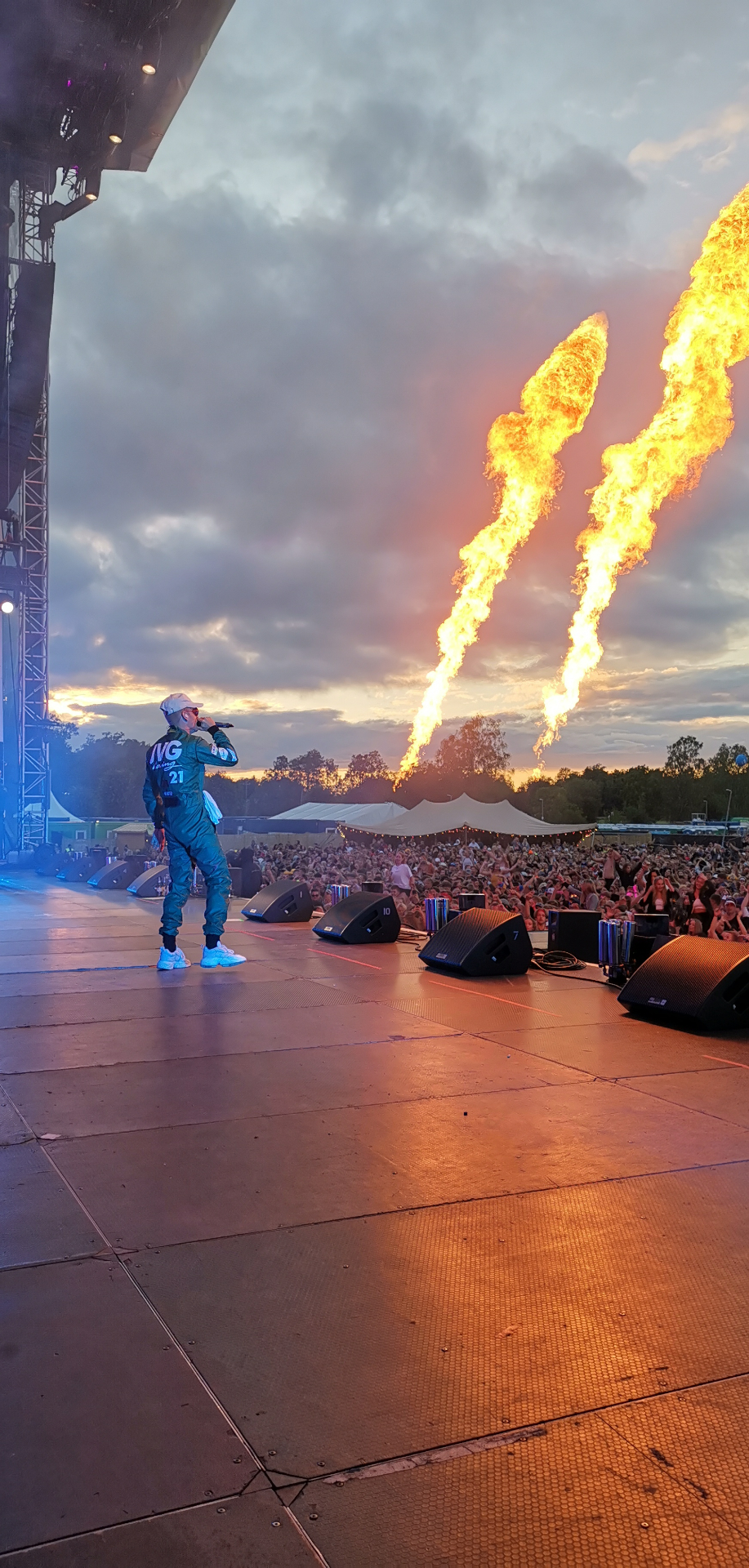 Festival stage with pyrotechnics at sunset