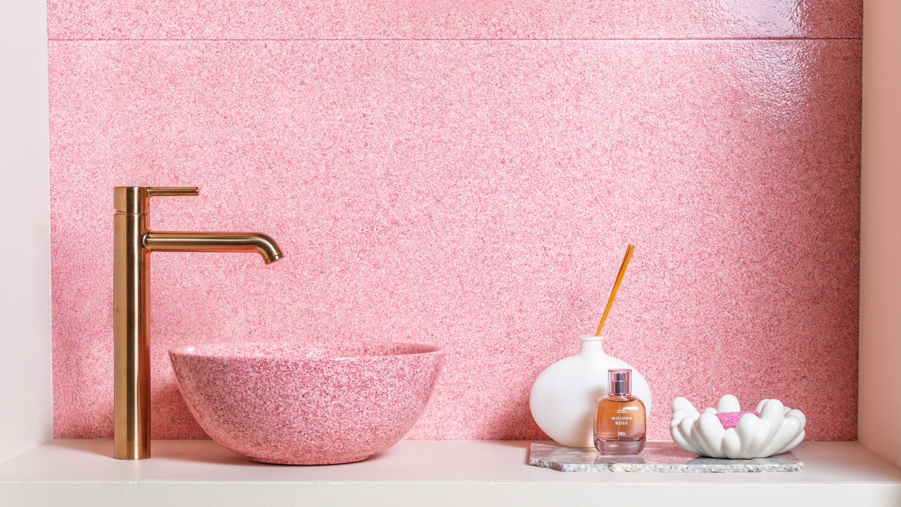 Pink terrazzo bathroom interior with brass faucet